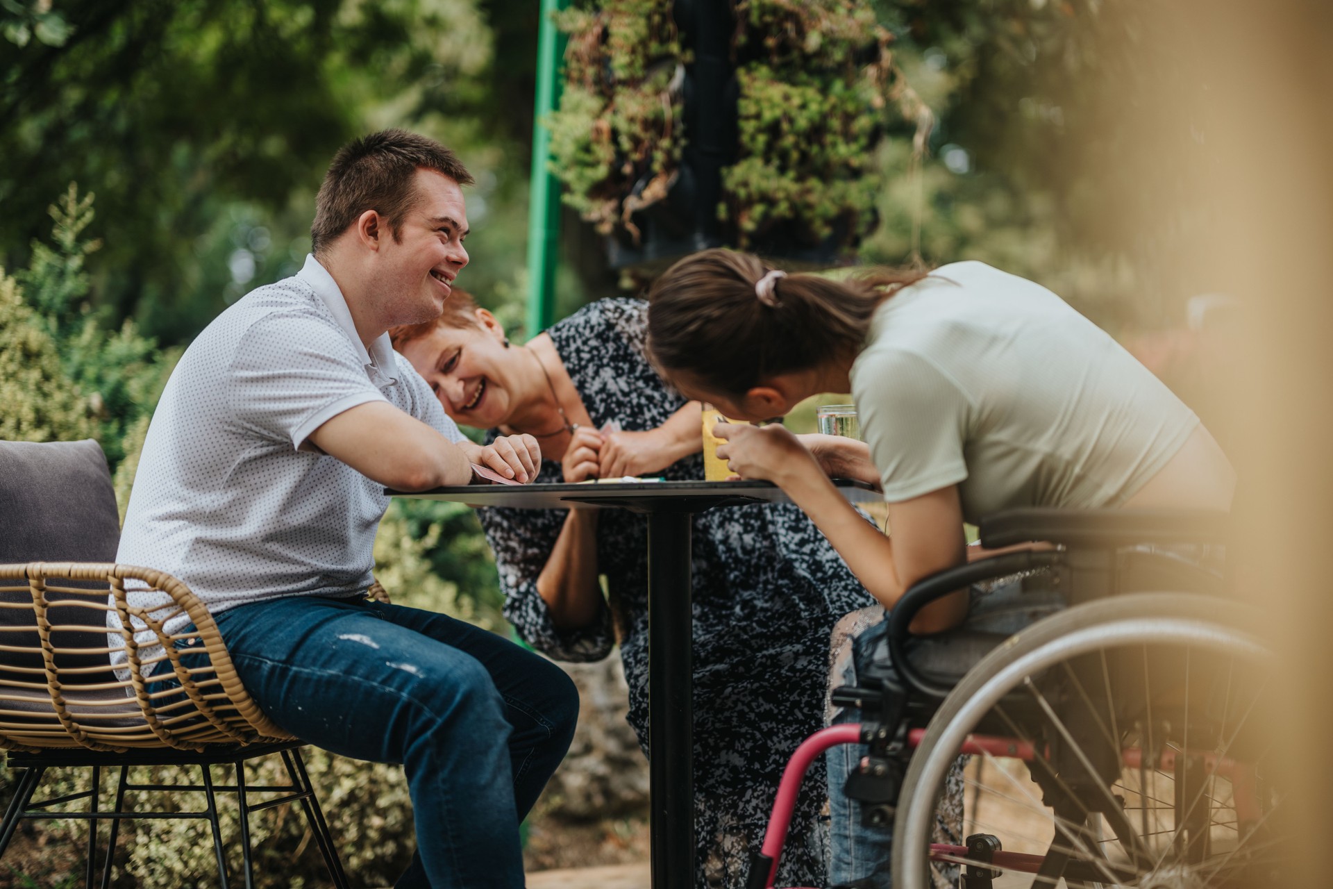 Friends with disabilities enjoying a joyful outdoor gathering