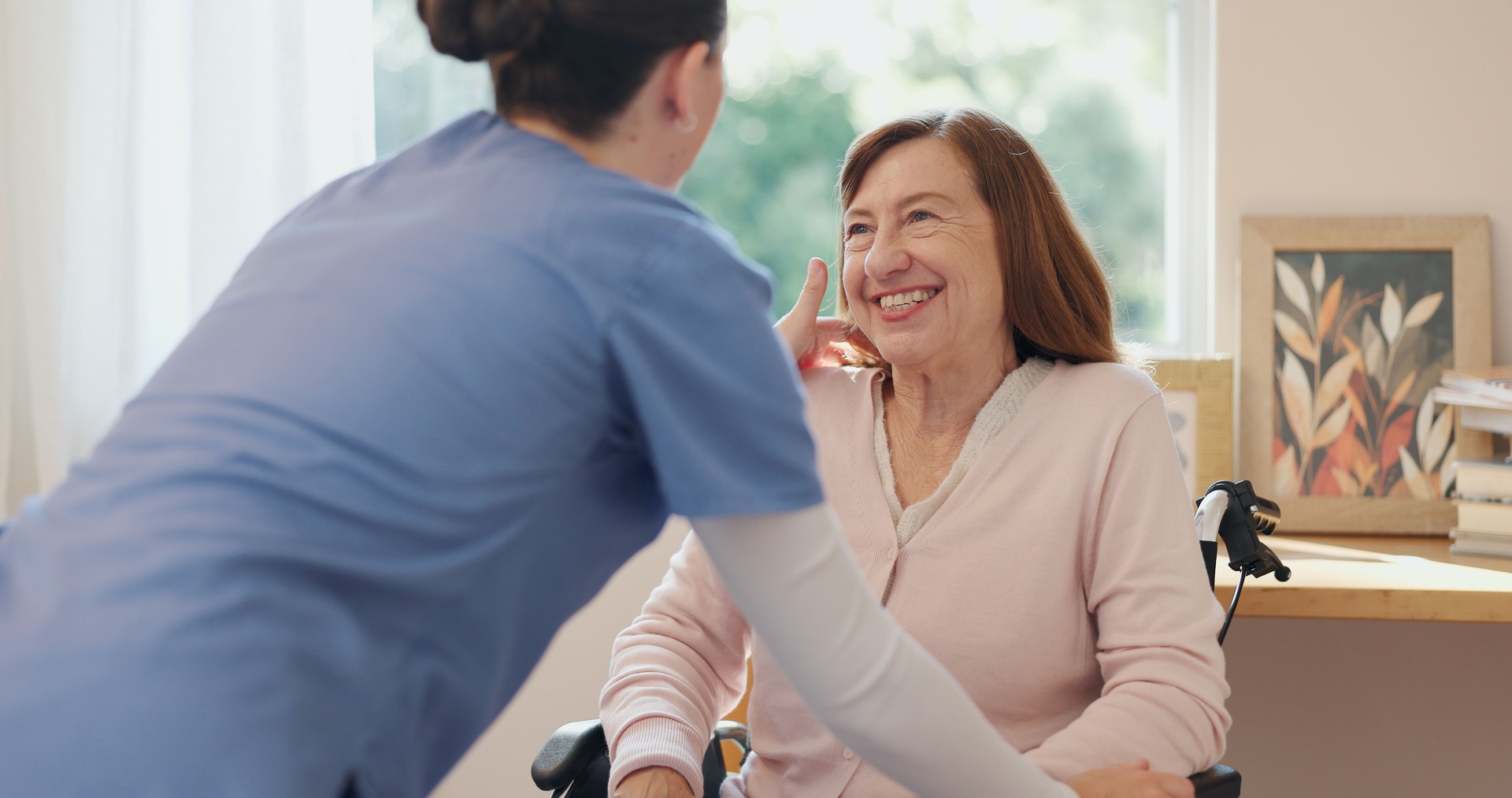 Nurse, support and wheelchair of elderly woman with smile for grooming, kindness and communication. Professional caregiver, happy and person with disability in home for healthcare, service and help